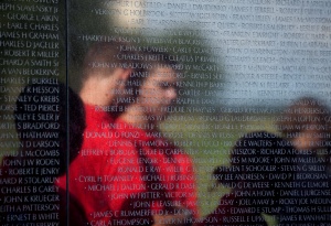 VISITORS REFLECTED IN VIETNAM VETERANS MEMORIAL IN WASHINGTON