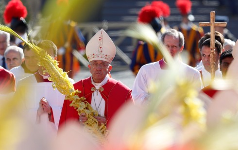 Pope Francis carries palm fronds in procession at start of Palm Sunday Mass in St. Peter's Square at Vatican